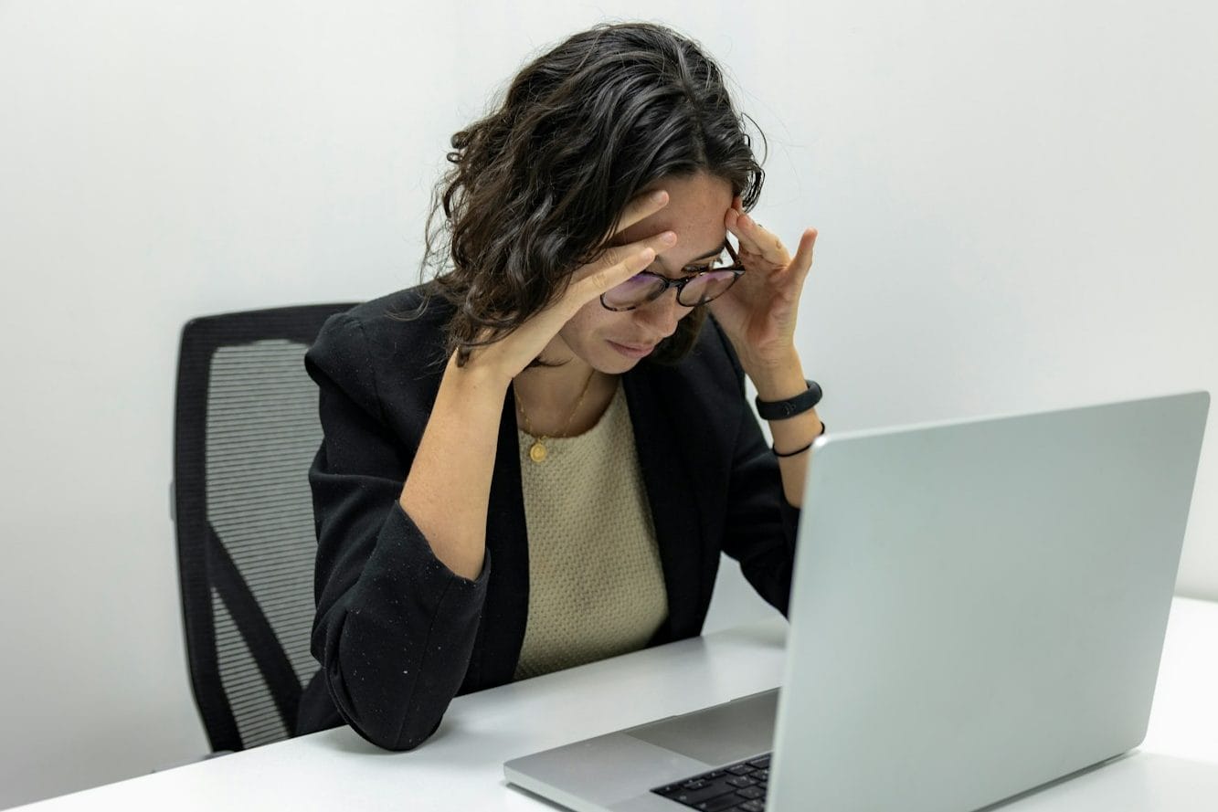 a woman sitting in front of a laptop computer